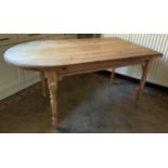 A pine kitchen table, with arched end, turned legs, 77cm high, 150cm long ** We would please ask