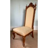 A 19th century walnut nursing chair, upholstered back and seat, turned freestanding columns,