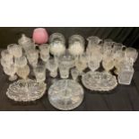 Glassware - a set of sixteen cut glass wine glasses; a cut glass decanter; a set of eighteen cut