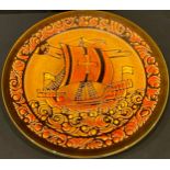 A Poole Pottery charger, the centre decorated with a galleon ship, printed and painted marks to