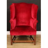 A George III Revival wingback armchair, 112.5cm high, 80cm wide, the set 46cm wide and 46cm deep