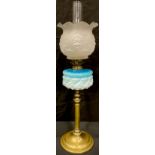 An Art Nouveau oil lamp, frosted glass shade, moulded blue and milk glass font, brass column on