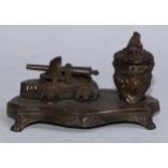 An early 20th century cold painted spelter novelty inkstand, the Rococo Revival well set beside a