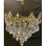 A 20th century brass chandelier purse shaped ceiling light, with glass pear shaped droplets