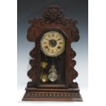 An early 20th century Ansonia gingerbread-form mantel or shelf alarm clock, 57cm high, 37cm wide,