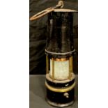 A miner's safety lamp, oval brass plate numbered 265