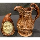 A Victorian character tobacco jar, as a friar; a treacle glazed gamekeeper's beer jug, lurcher