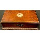 An early 20th century mahogany cigar box, the hinged cover applied with a shaped cartouche pierced