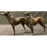 A pair of bronzed metal lurchers, 16.5cm high