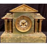 An onyx mantel clock, circular dial with Arabic numerals, twin winding holes