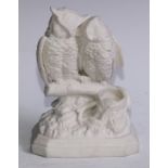 A 19th century parian ware table vesta, modelled as a pair of amorous owls perched on a branch,
