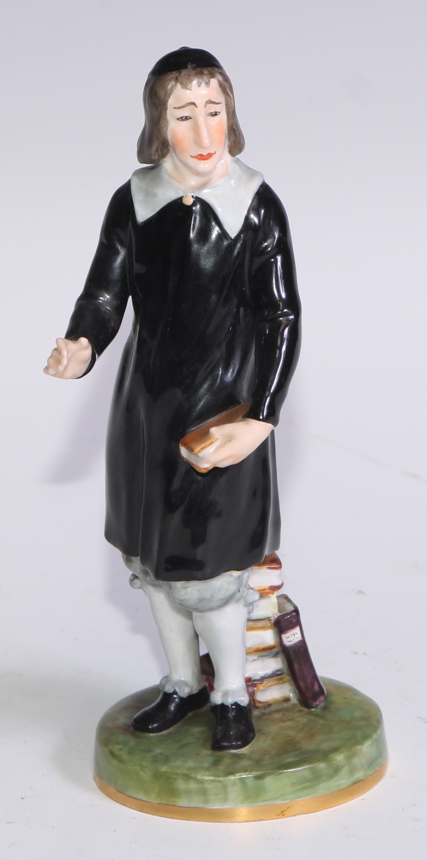 A Royal Crown Derby figure, San Grada, modelled with his books, 17cm high, printed mark