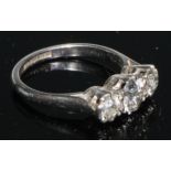 A three stone diamond ring, brilliant cut stones, platinum shank, size K/L