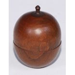 A 19th century turned fruitwood miniature apple shaped box and cover, containing a set of six