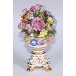 A Sampson Hancock Derby faux potpourri, decorated and encrusted with colourful summer flowers,