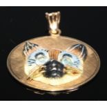 A 14ct gold cat pendant, enamel face, stone set eyes, 4cm in diameter, 22.7g gross
