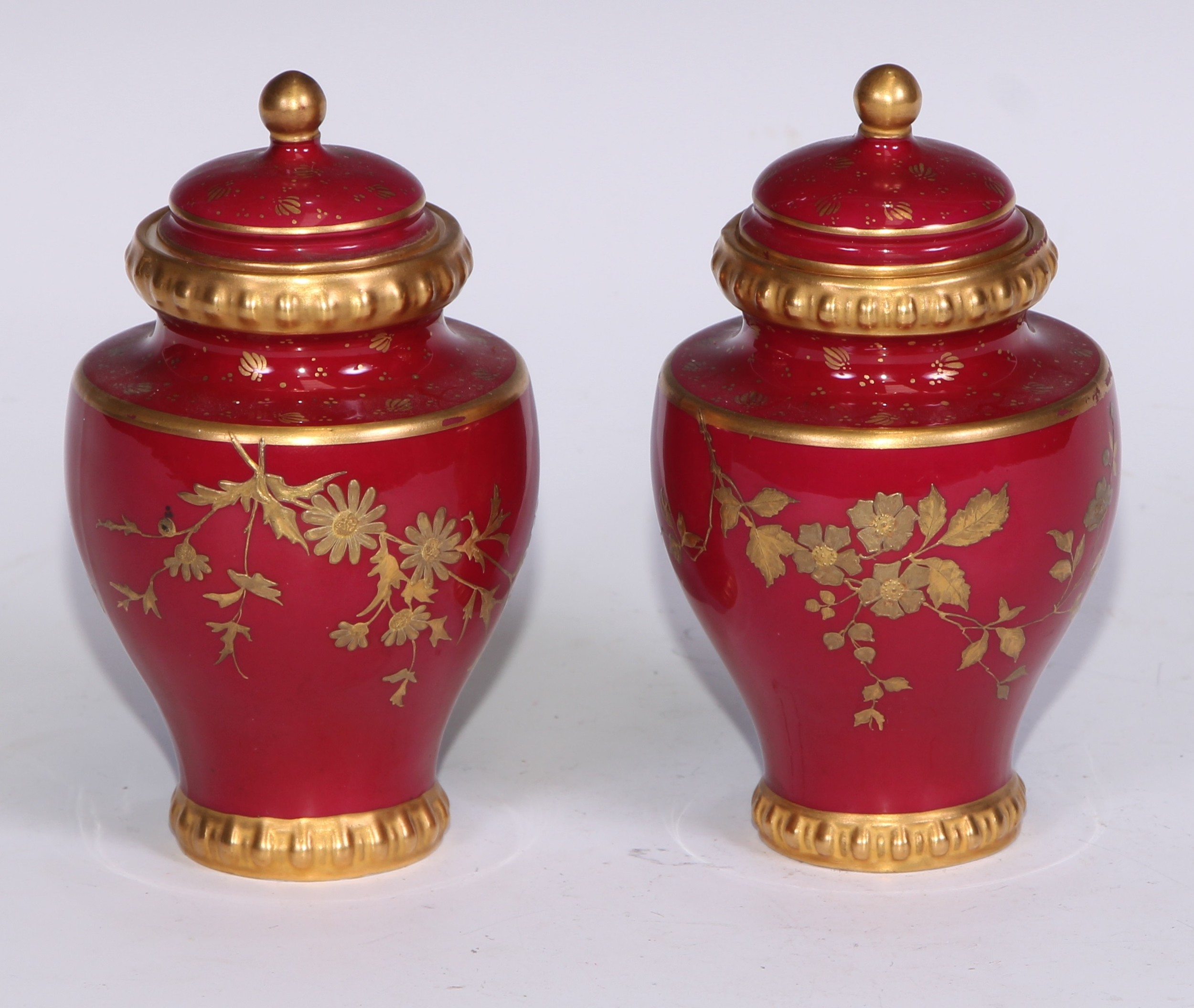 A pair of Royal Crown Derby baluster vases and covers, decorated in gilt with flowers and