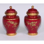 A pair of Royal Crown Derby baluster vases and covers, decorated in gilt with flowers and