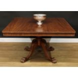 A mahogany breakfast table, rounded rectangular titling top, turned column, reeded legs, paw feet,