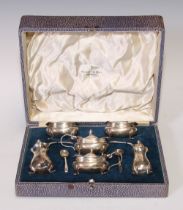 A George VI silver six piece condiment set, the peppers 8cm high, Chester 1939, 226g, cased