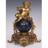 A Napoleon III ormolu and japanned mantel clock, cast as a Bacchic putto atop a celestial orb draped