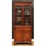 A Sheraton Revival mahogany and marquetry library bookcase, dentil cornice above a pair of