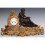 A late 19th century French gilt and bronzed metal figural mantel clock, 9.5cm circular enamel