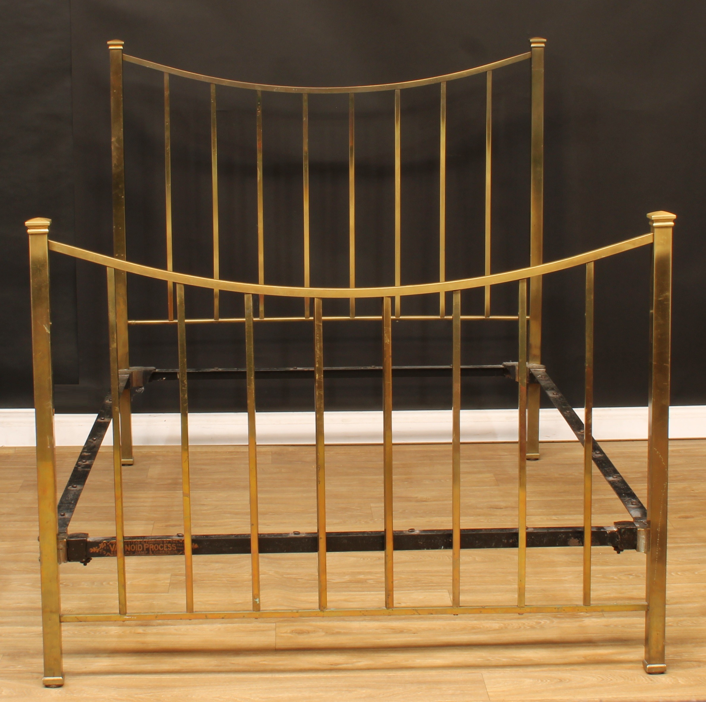 An Arts & Crafts brass bed, 139cm high, the internal 194cm x 140cm