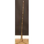 A brass tripod floor lamp, naturalistically cast as bamboo, 132.5cm high over fitting