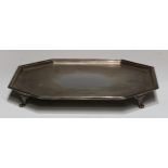 A George V silver canted square salver, of substantial gauge, reeded borders, lion paw feet, 35.