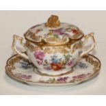 A Continental porcelain chocolate cup and stand, decorated with flowers and outlined with bands of