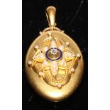 A Victorian oval diamond set locket in Etruscan Revival style, centered with an eight pointed star