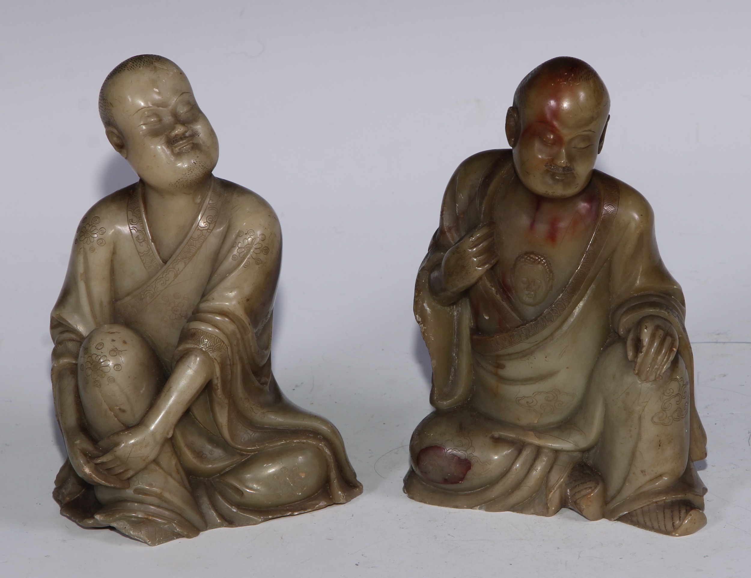 A Chinese soapstone figure, of a monk, seated, parting his robe, Buddha displayed on his chest, 12.