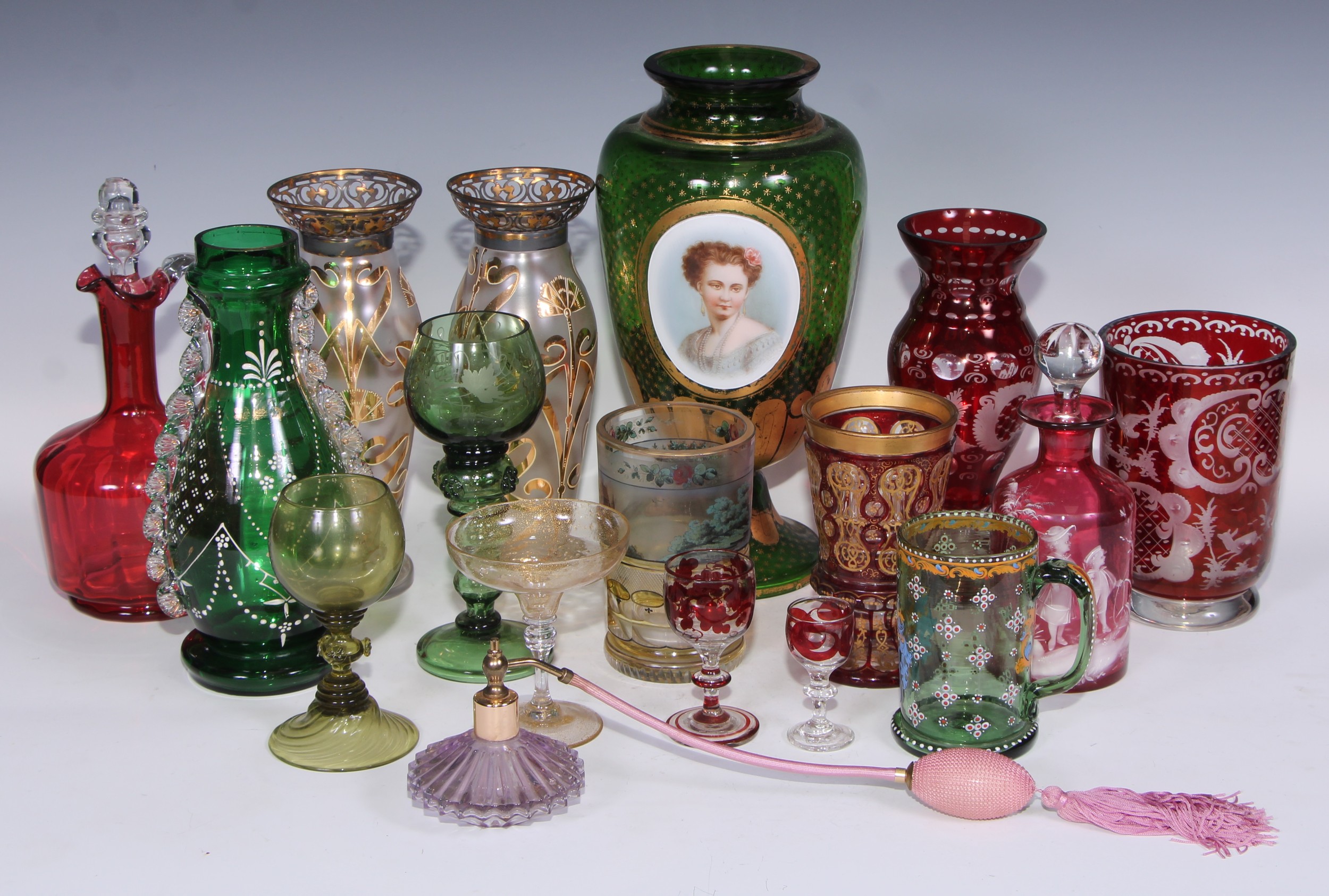 A Bohemian emerald glass vase, decorated in enamel with a portrait of a lady, on a ground of gilt