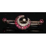 A Victorian ruby, diamond and pearl crescent brooch, inset with seventeen graduated pinky red
