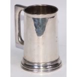 A Victorian silver beer mug, quite plain, angular handle, clear glass base, skirted foot, 14cm high,