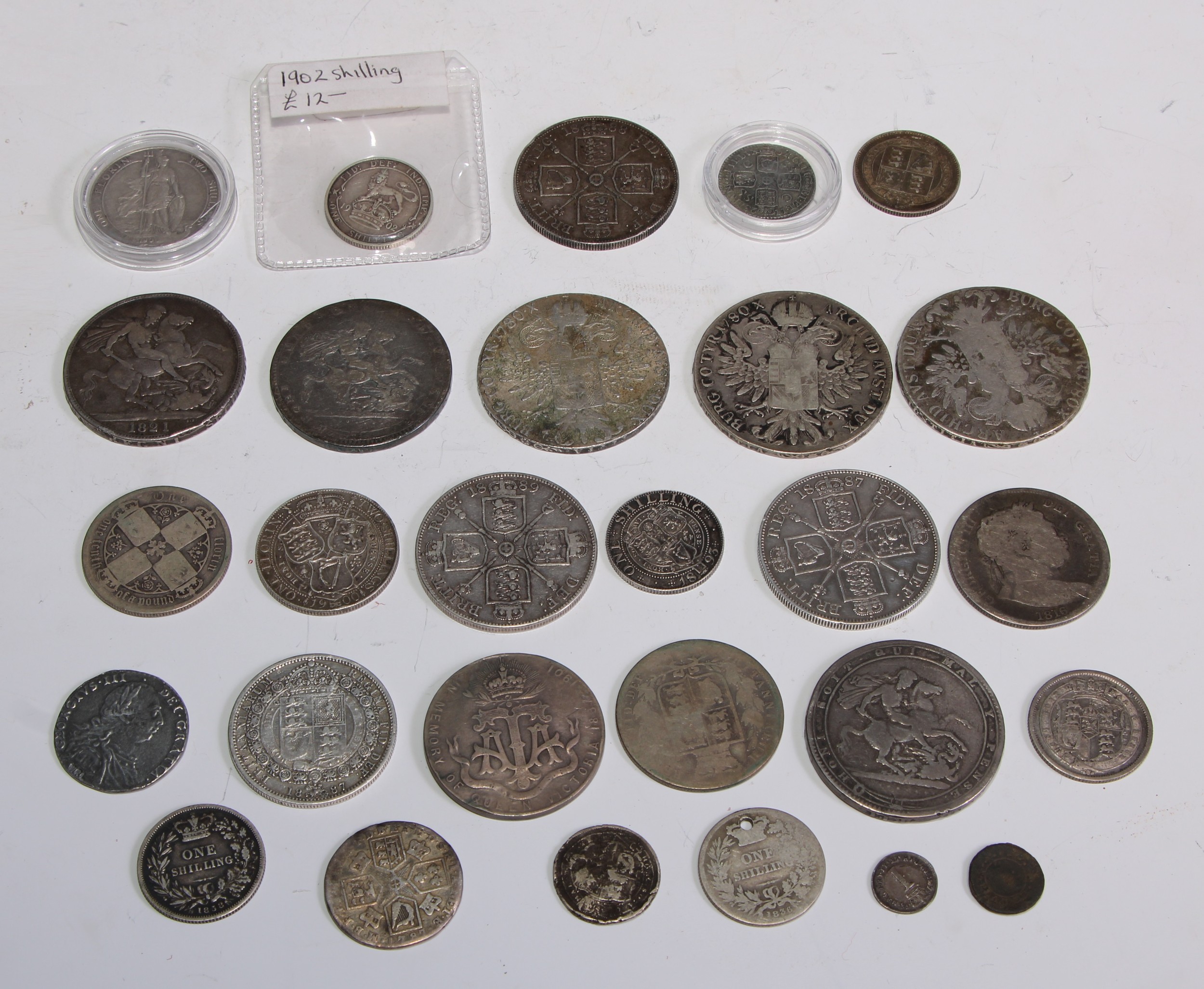 Coins -a George IV crown, 1821; a Victorian double florin, 1888; another, 1887; a George I sixpence,