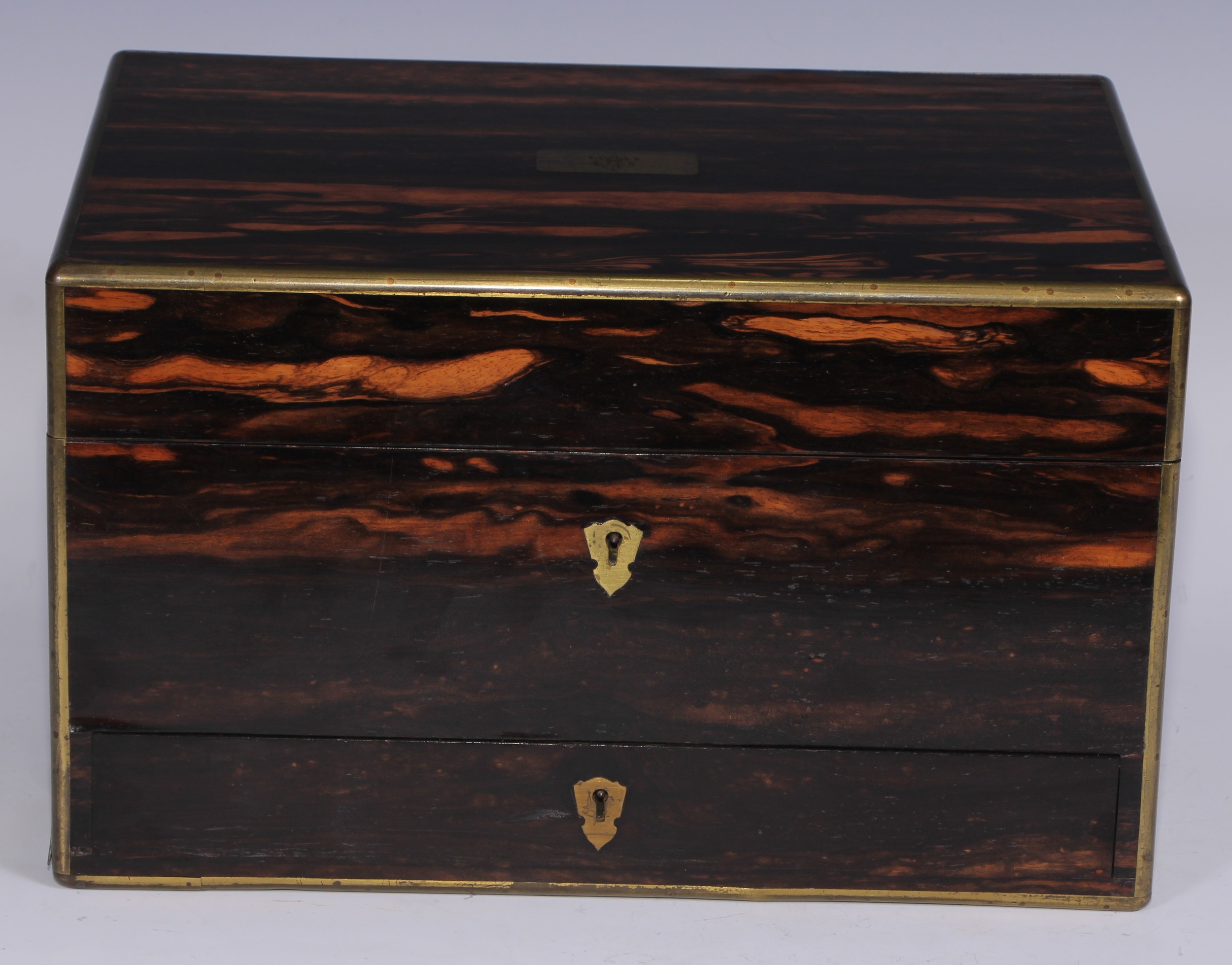 A Victorian brass bound coromandel rectangular dressing box, hinged cover enclosing an arrangement