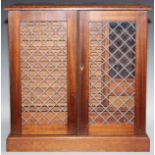 A mahogany table top coin collector's cabinet, the faux-leaded glazed doors enclosing sliding
