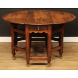 An 18th century oak double-gateleg table, oval top with fall leaves above a single frieze drawer,
