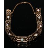 A 9ct gold gate bracelet, each of the eight three-bar panels centered with an oval cabochon opal,