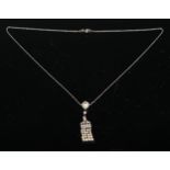 An Art Deco diamond and seed pearl fringe pendant, with single larger pearl, seven old cut