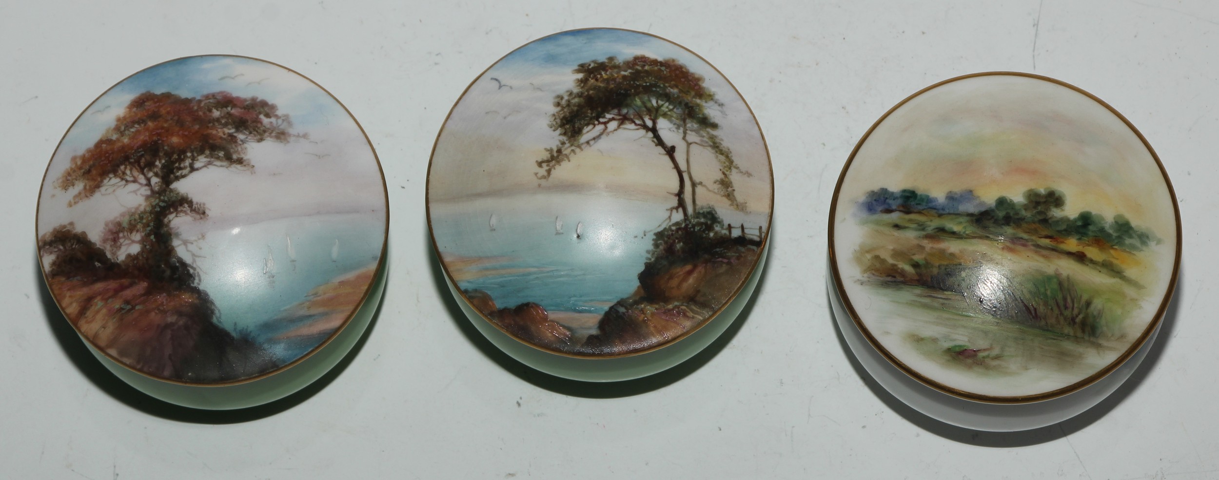 A Royal Worcester topographical trinket box and cover, painted with a coastal landscape, apple green