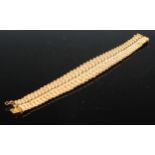 An 18ct matt and burnished gold interlinked bowed rope twist bracelet, 19cm long, 46g