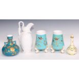 A pair of Derby Crown Porcelain Aesthetic Movement spill vases, decorated in gilt on a turquoise