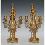 A pair of 19th century French porcelain mounted gilt metal three-light candelabra, in the Louis