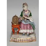 A Derby figure, of a lady with a bird cage, shaped square base, 15cm high, incised mark, pseudo-