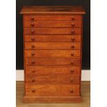 An early 20th century oak collector’s chest, rectangular top above ten long drawers, 84cm high, 56cm