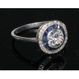 A diamond and sapphire ring, central round brilliant cut diamond approx 1.15ct, surrounded by two