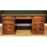 An oak twin pedestal desk, rectangular top with inset writing surface above three frieze drawers,